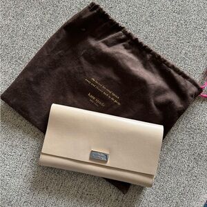 I am selling a Kate spade gray clutch with a pink color interior.